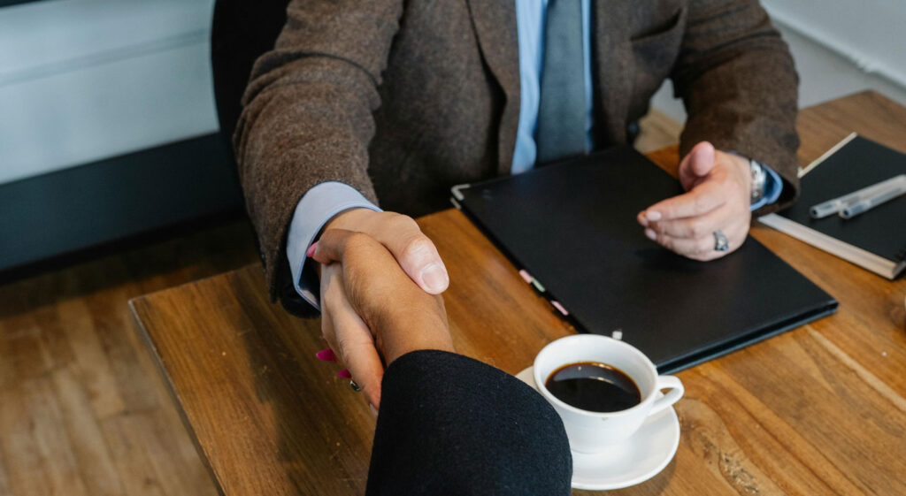 Handshake over a coffee meeting