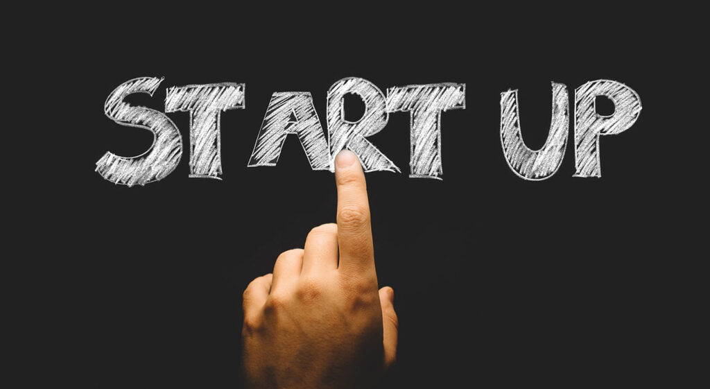 Hand pointing at "START UP"